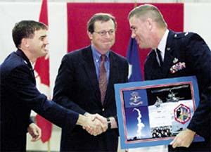 NASA astronaut LTC Rex Walheim presents LTC David Doryland with a plaque commemorating shuttle mission STS-110.